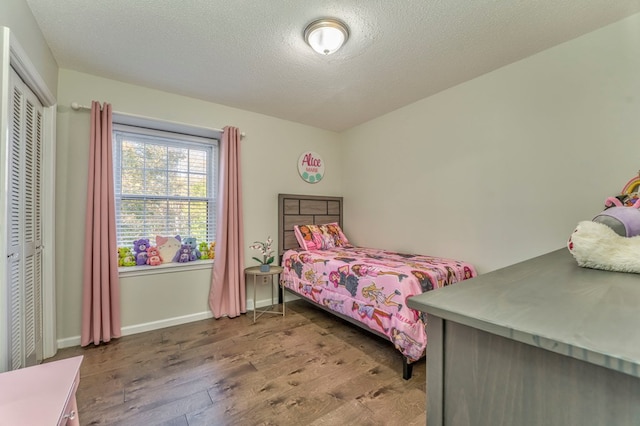432 Castle Rd, Dalton, GA 30720 - bedroom featuring wood-type flooring, a closet, and a textured ceiling