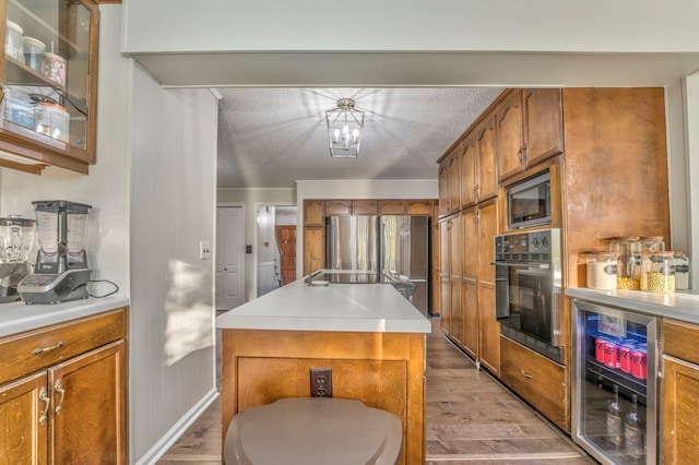 432 Castle Rd, Dalton, GA 30720 - kitchen with a kitchen island, appliances with stainless steel finishes, wine cooler, and light hardwood / wood-style flooring