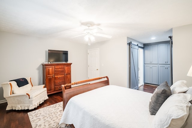 103 Paddle Wheel Ct, Cohutta, GA 30720 - bedroom featuring a barn door, dark wood-style flooring, and ceiling fan