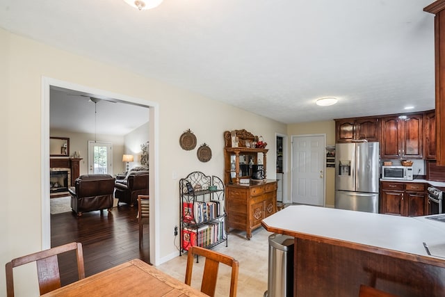 103 Paddle Wheel Ct, Cohutta, GA 30720 - kitchen with appliances with stainless steel finishes, a fireplace, baseboards, and open floor plan