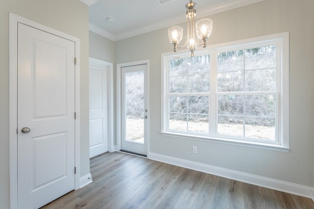 191 Andros Dr, Dalton, GA 30721 - unfurnished dining area featuring wood finished floors, a chandelier, ornamental molding, baseboards, and healthy amount of natural light