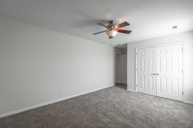 unfurnished bedroom with ceiling fan, carpet floors, and a closet