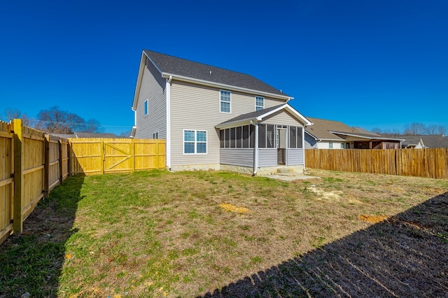 back of property featuring a lawn and a sunroom