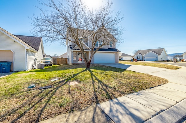 view of front of home with a garage, a front lawn, and central air condition unit