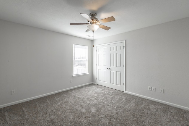 unfurnished bedroom with ceiling fan, carpet floors, and a closet