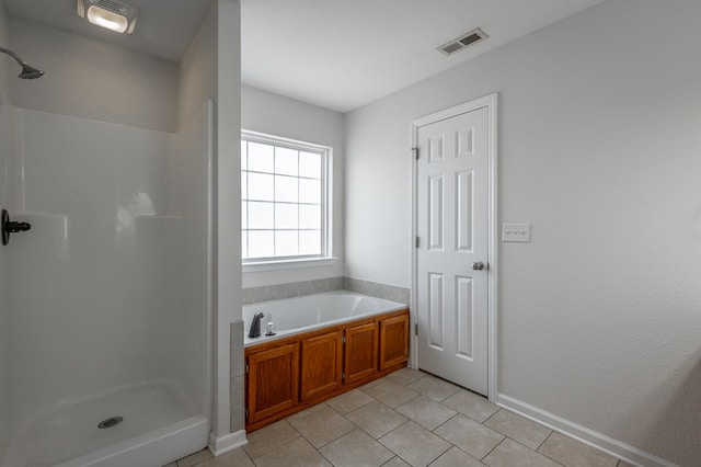 bathroom with tile patterned flooring and separate shower and tub