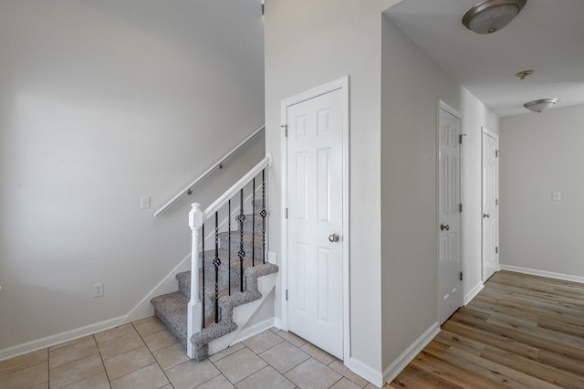 stairway with tile patterned floors