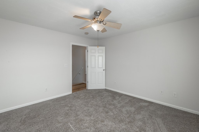 carpeted empty room featuring ceiling fan