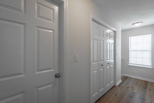 hallway with light hardwood / wood-style floors