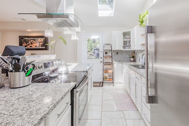 kitchen featuring white cabinetry, appliances with stainless steel finishes, sink, and light stone counters