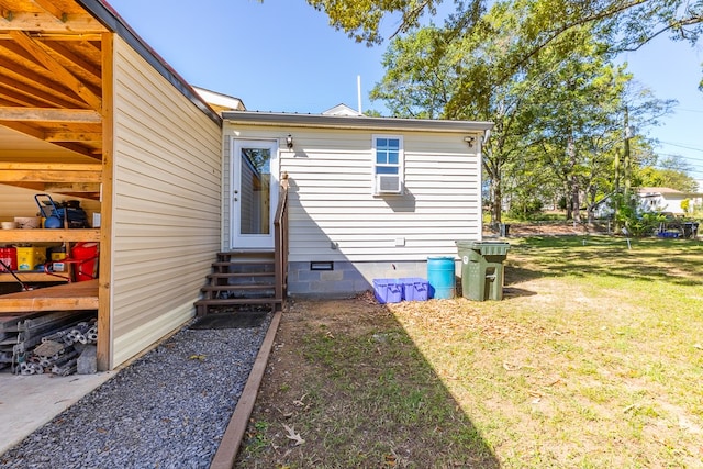 rear view of property featuring a yard