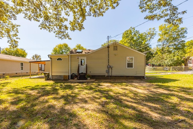 rear view of house with a lawn