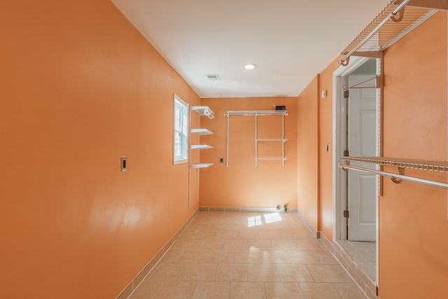 hallway featuring light tile patterned floors