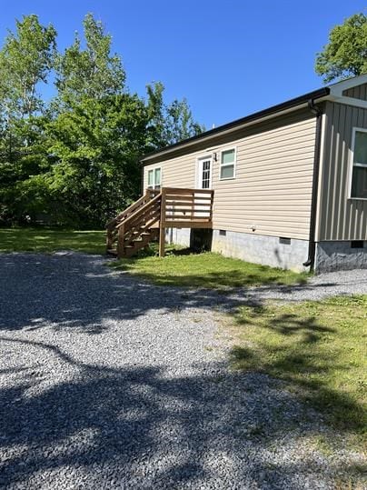 view of side of home with a lawn