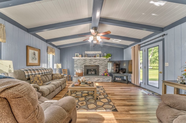 1164 Holly Grove Cir, Dalton, GA 30720 - living area featuring ceiling fan, a brick fireplace, wood walls, wood finished floors, and lofted ceiling with beams