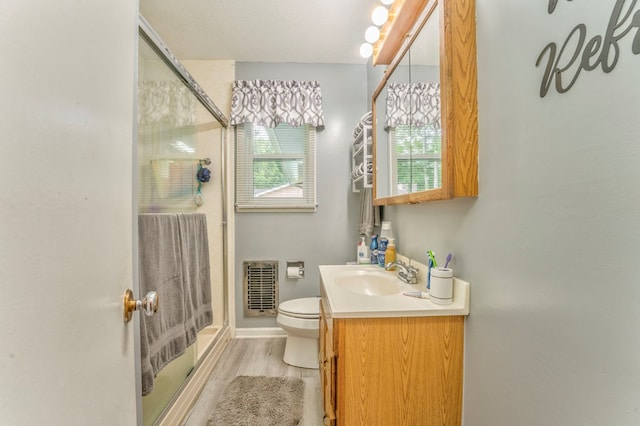 1164 Holly Grove Cir, Dalton, GA 30720 - full bathroom featuring a stall shower, heating unit, toilet, vanity, and wood finished floors