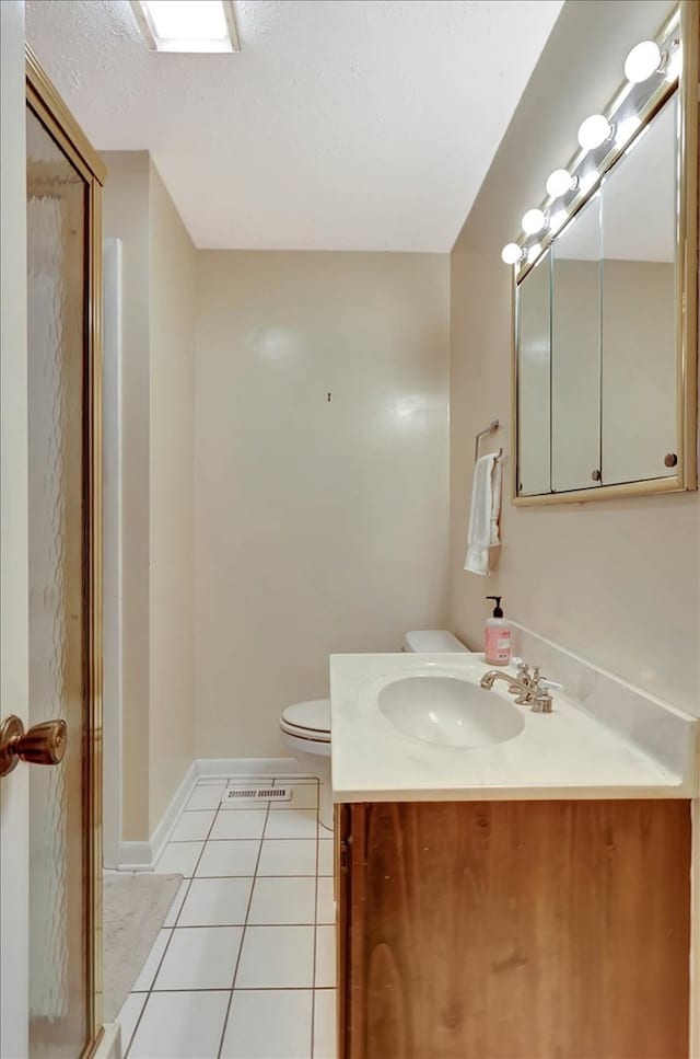 153 Buckingham Dr, Dalton, GA 30720 - full bathroom featuring toilet, tile patterned floors, vanity, a shower with shower door, and a textured ceiling
