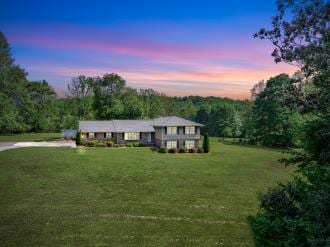 153 Buckingham Dr, Dalton, GA 30720 - tri-level home with a front lawn, a view of trees, and driveway
