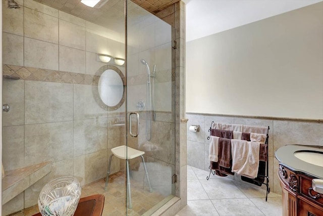 153 Buckingham Dr, Dalton, GA 30720 - full bath featuring tile walls, a stall shower, vanity, tile patterned floors, and a wainscoted wall