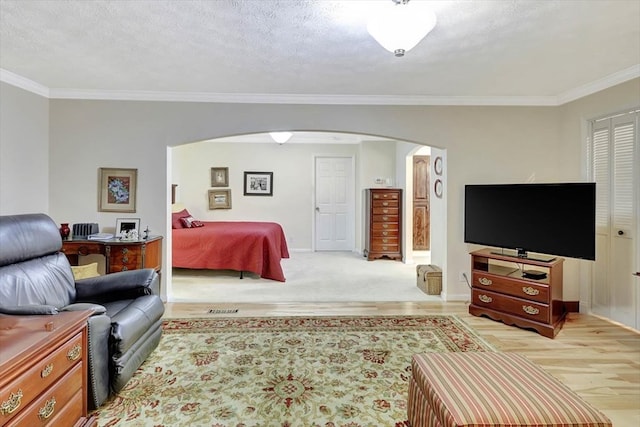 153 Buckingham Dr, Dalton, GA 30720 - bedroom featuring arched walkways, ornamental molding, baseboards, and light wood-type flooring