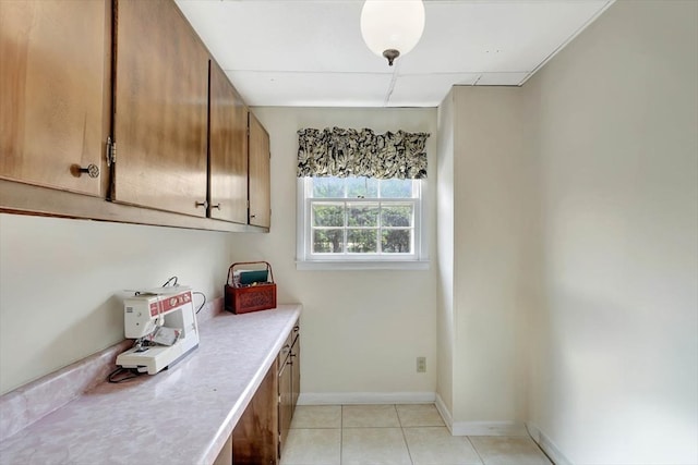 153 Buckingham Dr, Dalton, GA 30720 - kitchen with light countertops, brown cabinets, baseboards, and light tile patterned floors