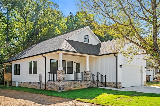 modern farmhouse style home with a garage, a front yard, and covered porch