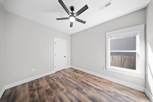 spare room featuring ceiling fan and dark hardwood / wood-style flooring