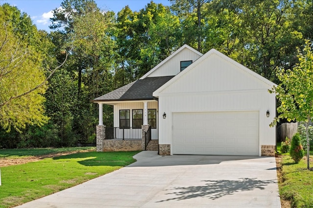 view of front of property featuring a garage, a front lawn, and a porch