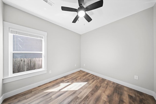 empty room featuring ceiling fan and dark hardwood / wood-style floors