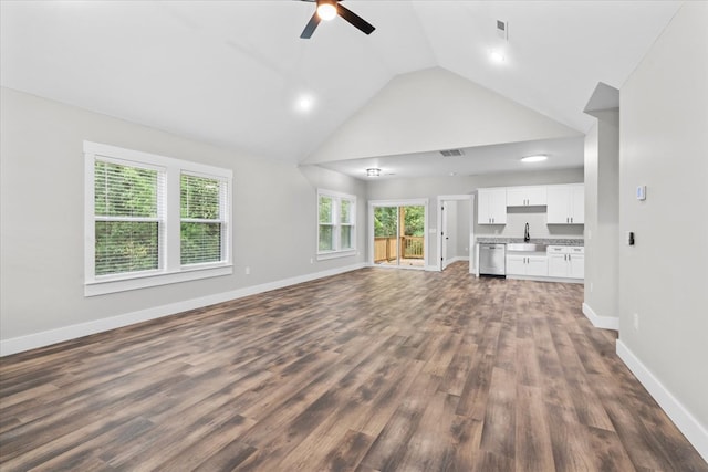 unfurnished living room with ceiling fan, sink, dark wood-type flooring, and high vaulted ceiling