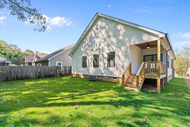 back of house with a yard, central AC unit, and ceiling fan