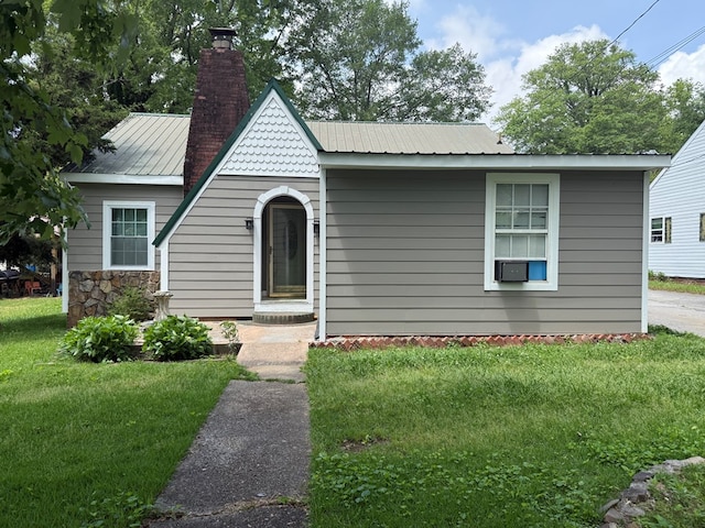 406 Lester Ave, Dalton, GA 30721 - view of front facade with a chimney, a front lawn, and metal roof