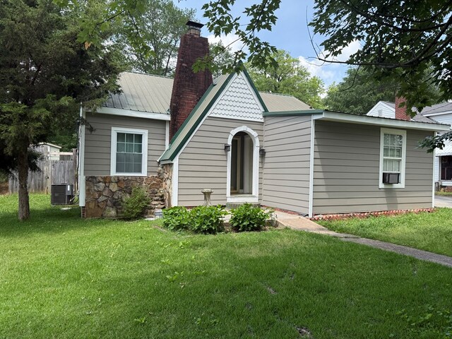406 Lester Ave, Dalton, GA 30721 - view of front facade with a chimney, cooling unit, metal roof, and stone siding