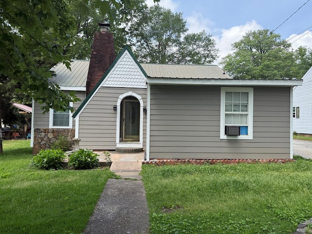 406 Lester Ave, Dalton, GA 30721 - view of front of home with a chimney, a front lawn, and metal roof