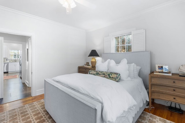 bedroom featuring ornamental molding, hardwood / wood-style floors, and ceiling fan