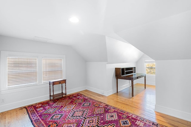 bonus room with lofted ceiling and hardwood / wood-style flooring