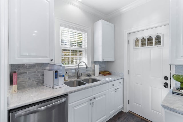 kitchen with sink, white cabinets, ornamental molding, stainless steel dishwasher, and light stone countertops