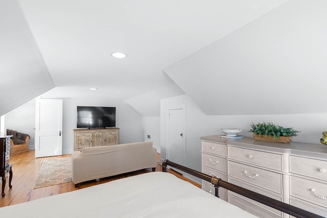 bedroom featuring lofted ceiling and light hardwood / wood-style floors