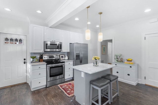 kitchen featuring stainless steel appliances, white cabinetry, dark hardwood / wood-style flooring, and decorative light fixtures