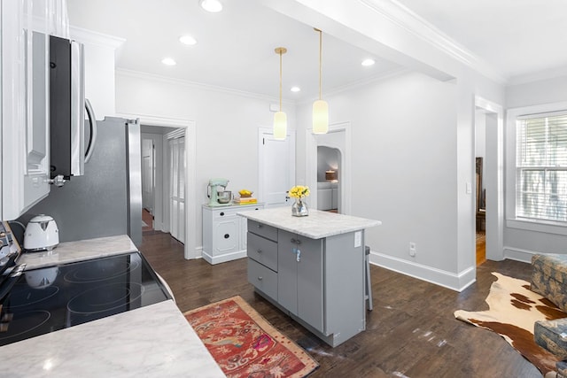 kitchen with dark wood-type flooring, gray cabinetry, stainless steel appliances, a center island, and decorative light fixtures