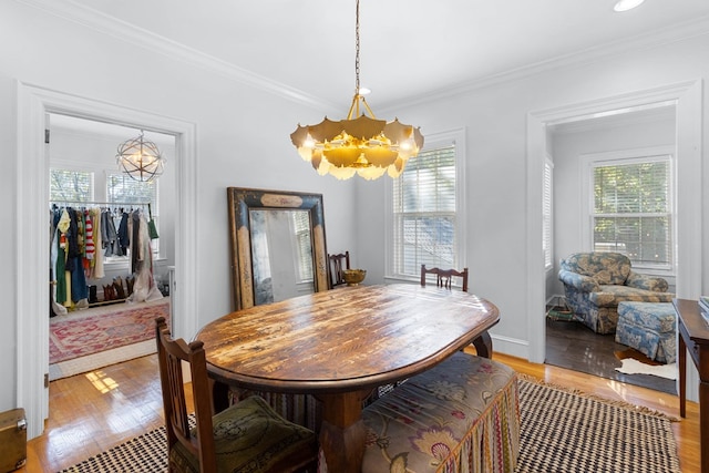 dining area with an inviting chandelier, plenty of natural light, and light wood-type flooring