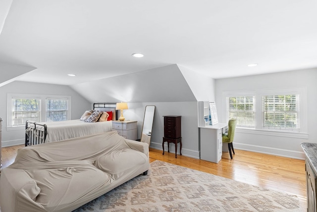 bedroom featuring vaulted ceiling and light hardwood / wood-style flooring