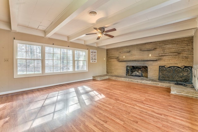 282 Cedar Ridge Rd, Dalton, GA 30721 - unfurnished living room featuring beam ceiling, a ceiling fan, a fireplace, wood finished floors, and visible vents