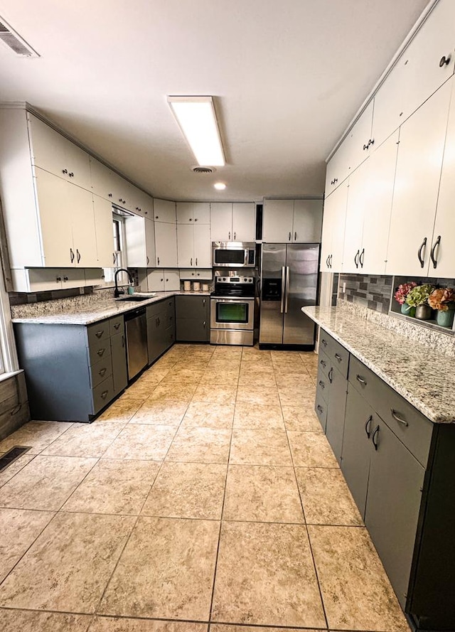 282 Cedar Ridge Rd, Dalton, GA 30721 - kitchen with white cabinetry, light tile patterned flooring, a sink, visible vents, and appliances with stainless steel finishes