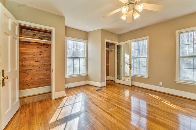 282 Cedar Ridge Rd, Dalton, GA 30721 - unfurnished bedroom featuring light wood finished floors, multiple windows, two closets, and baseboards