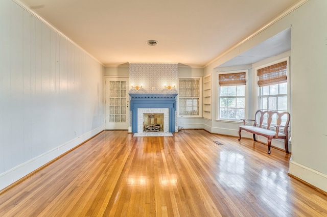 282 Cedar Ridge Rd, Dalton, GA 30721 - unfurnished living room with wood-type flooring, a brick fireplace, baseboards, visible vents, and ornamental molding
