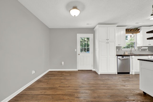 478 Dedmon Rd, Ringgold, GA 30736 - kitchen with stainless steel dishwasher, dark countertops, white cabinetry, a textured ceiling, and dark wood-style floors