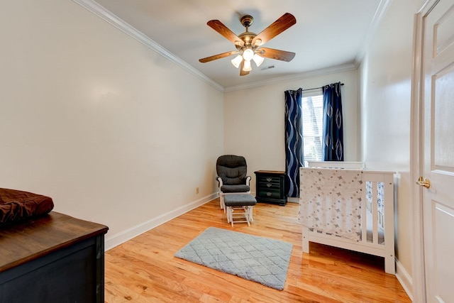 sitting room featuring crown molding, ceiling fan, and light hardwood / wood-style flooring