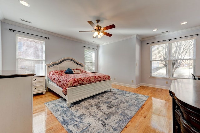 bedroom with crown molding, ceiling fan, and light hardwood / wood-style floors