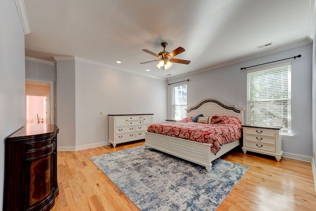 bedroom featuring ornamental molding, ceiling fan, and light wood-type flooring